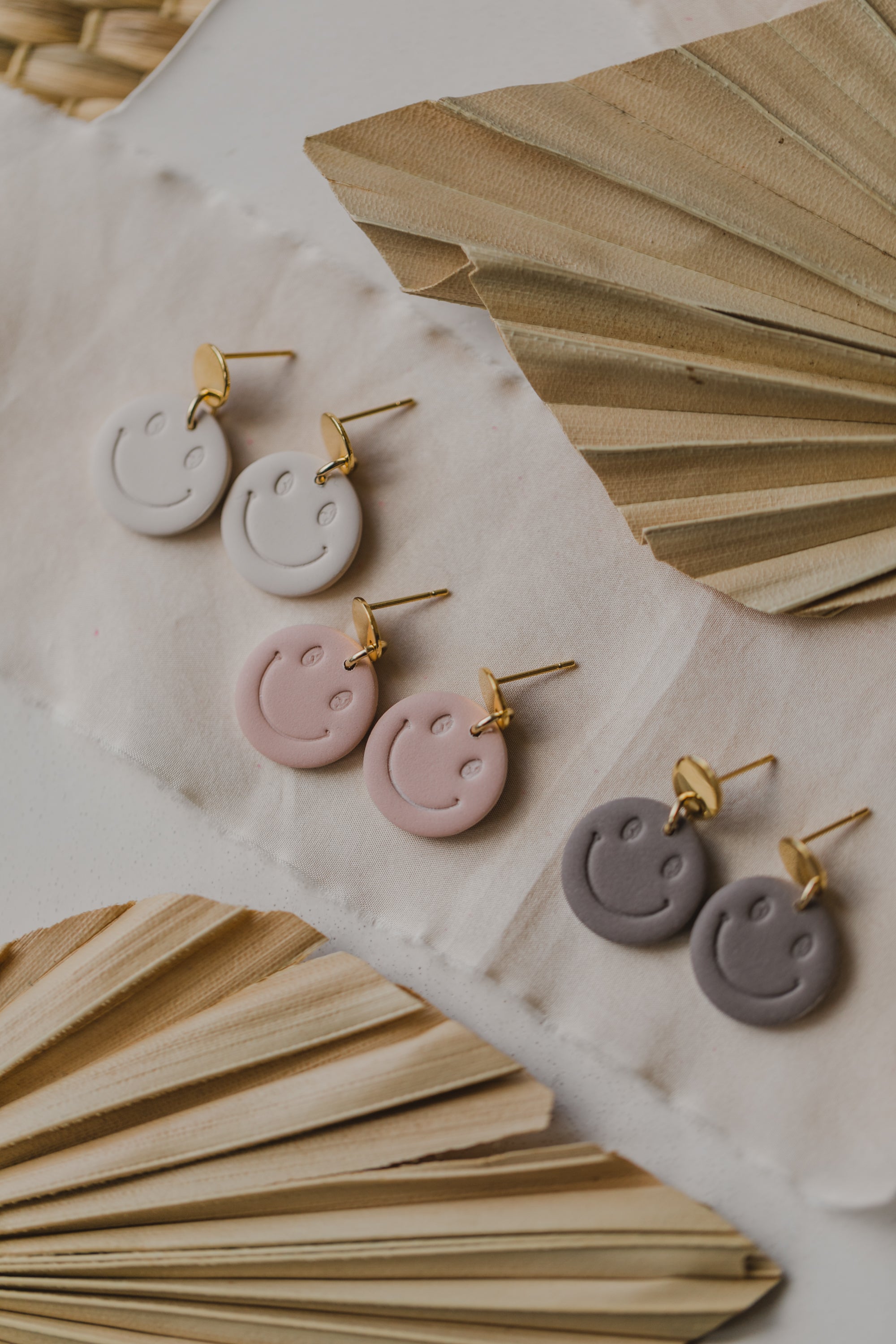 Smiley earrings made of polymer clay in soft colors