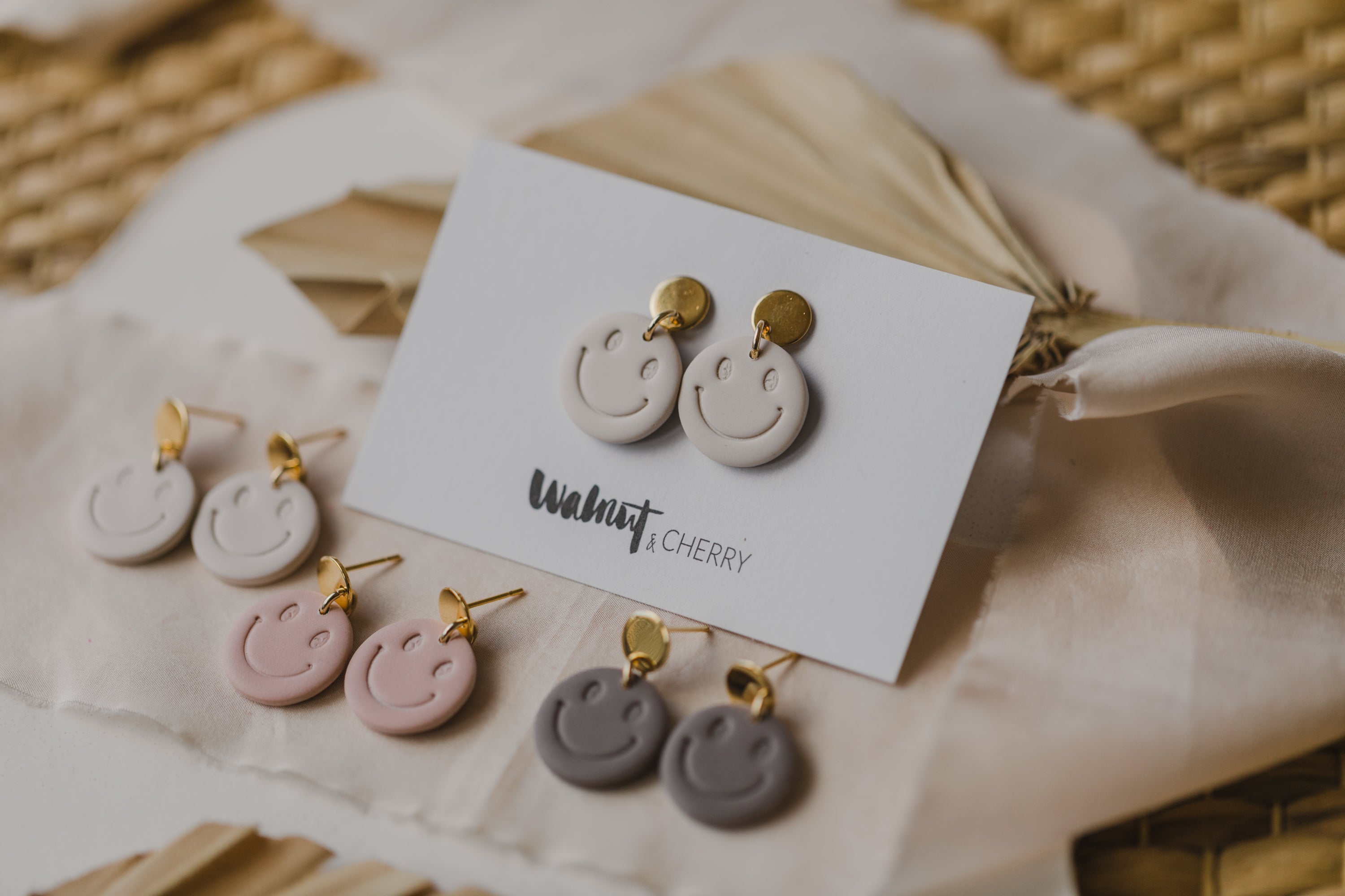 Smiley earrings made of polymer clay in soft colors
