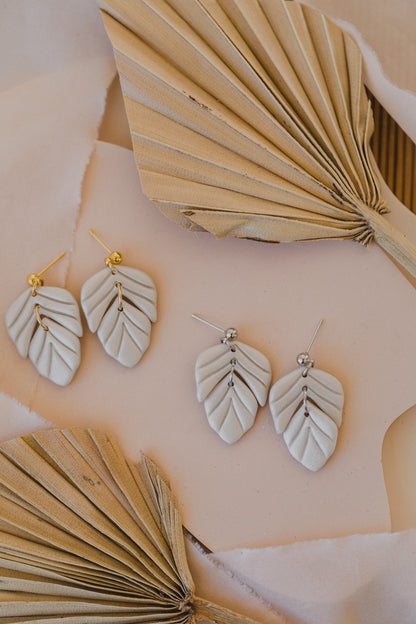 golden earrings with acrylic in white, petrol and brown