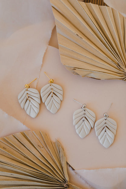 golden earrings with acrylic in white, petrol and brown