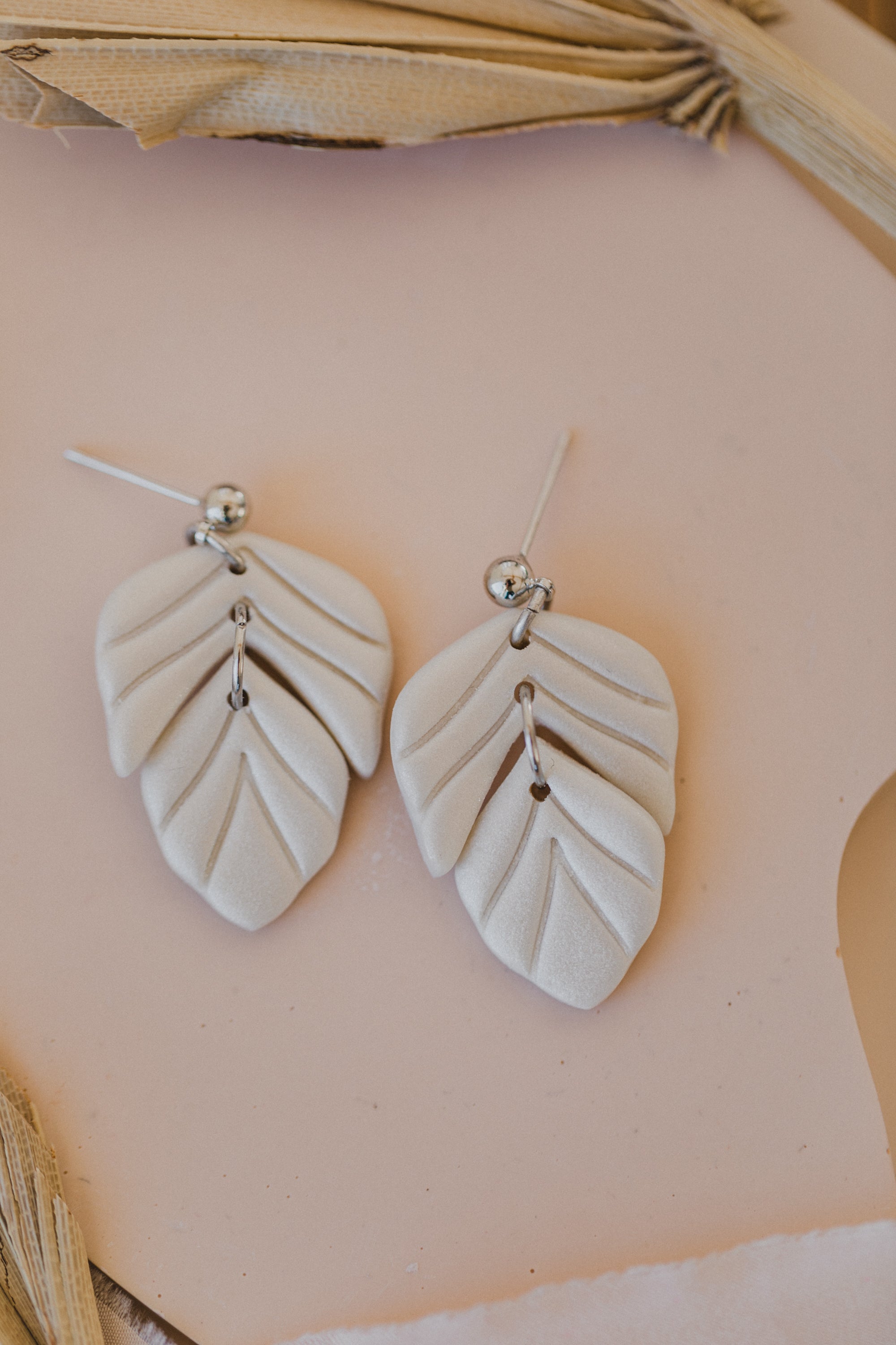golden earrings with acrylic in white, petrol and brown