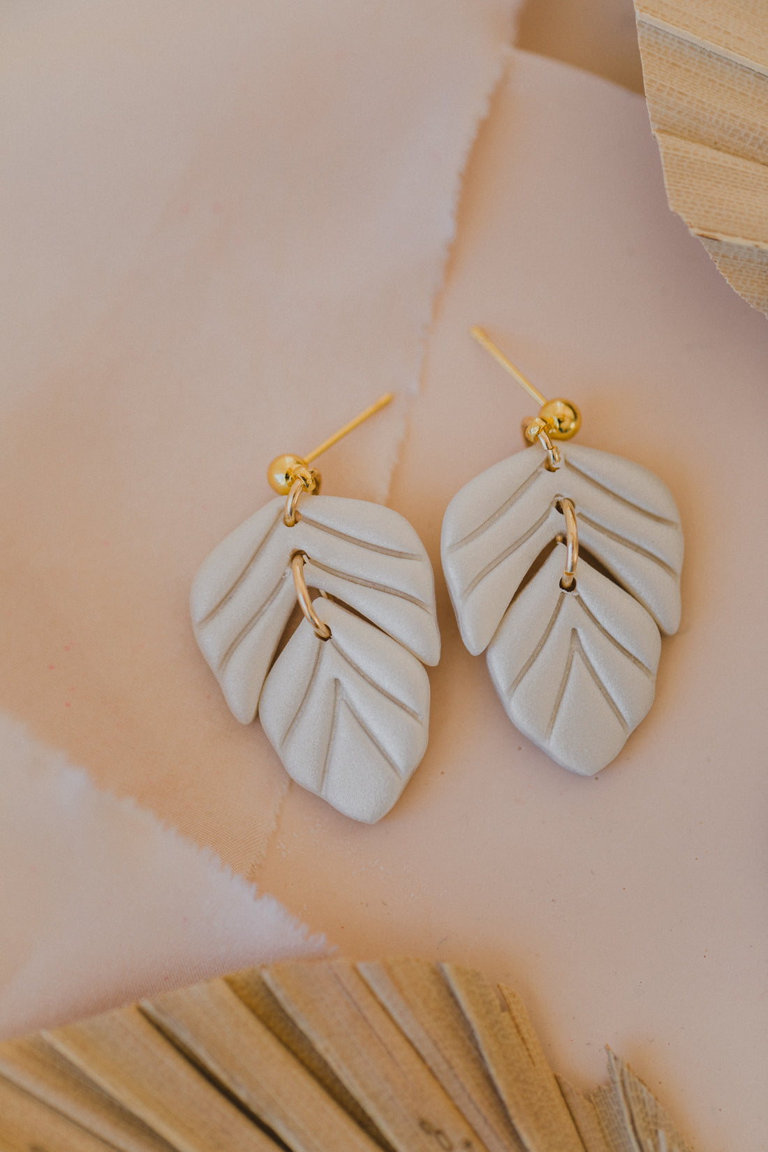 golden earrings with acrylic in white, petrol and brown