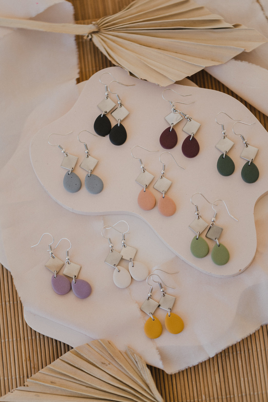 golden earrings with acrylic in white, petrol and brown