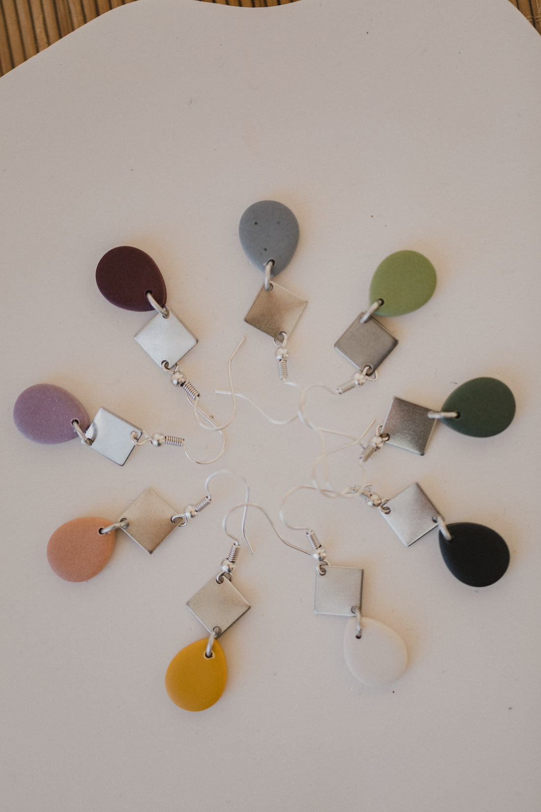 golden earrings with acrylic in white, petrol and brown