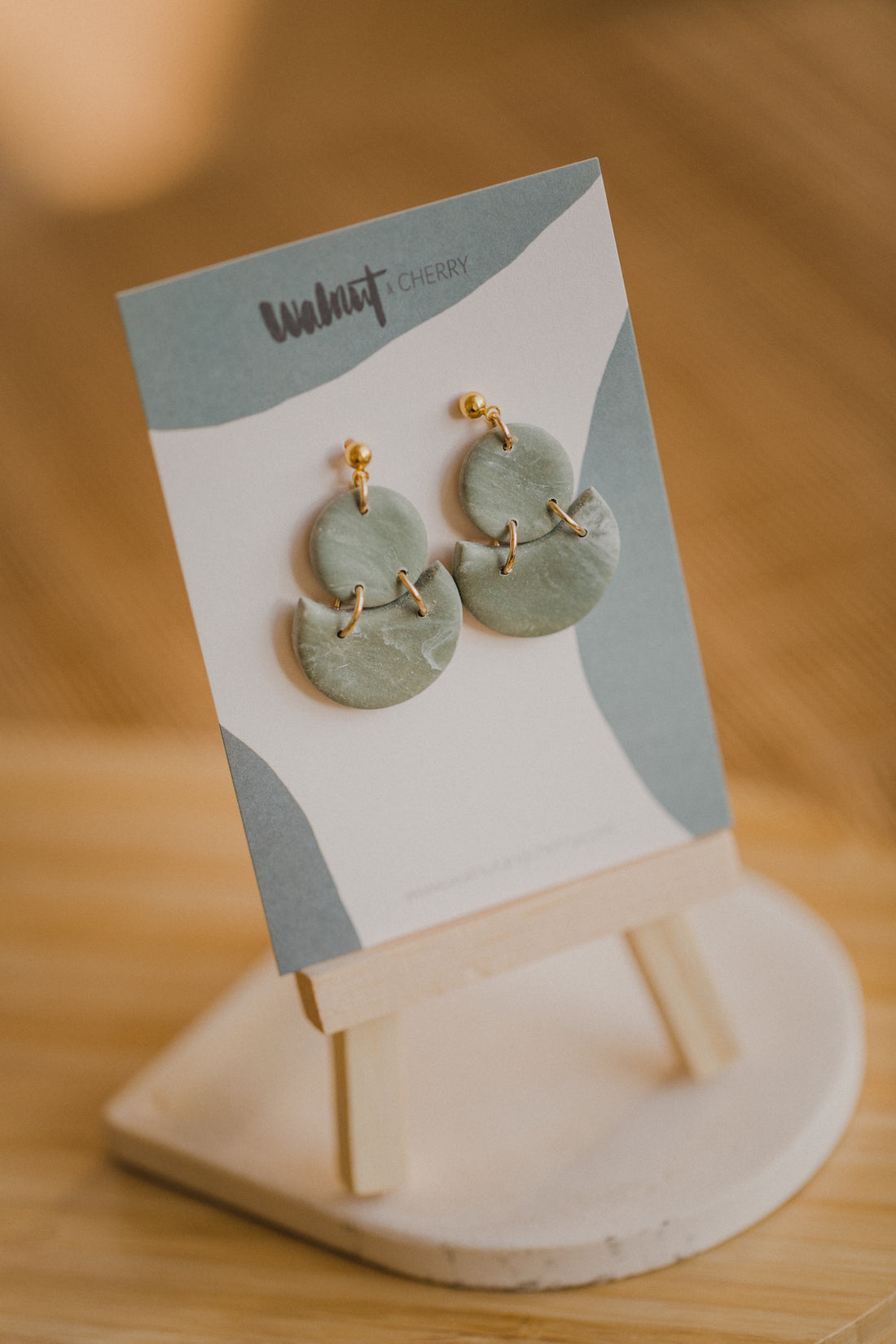 Hoop earrings with round polymer clay pendant and leaf