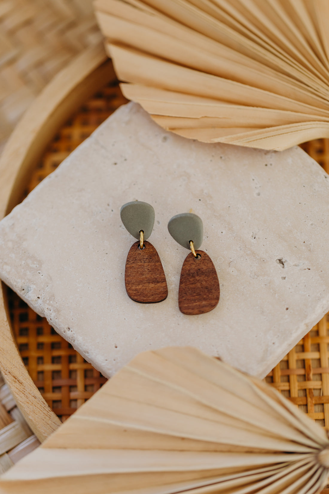 triangular polymer clay earrings in eucalyptus green with rectangular wooden pendant