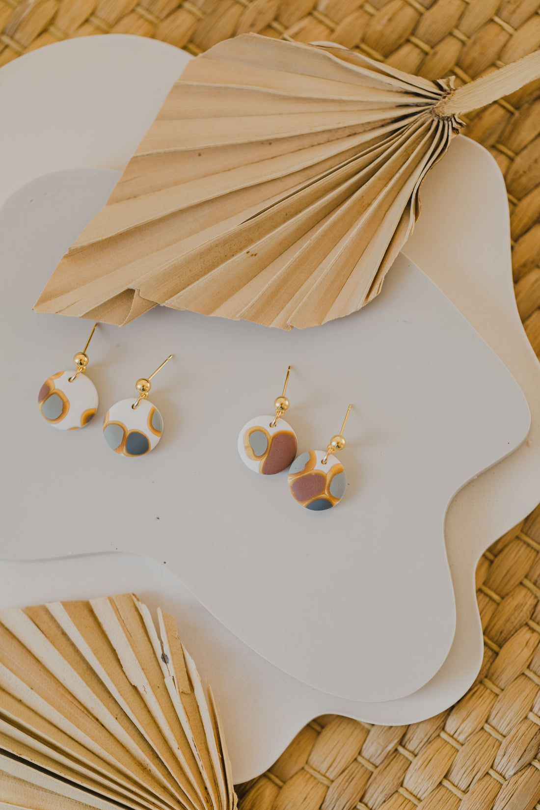 golden earrings with acrylic in white, petrol and brown