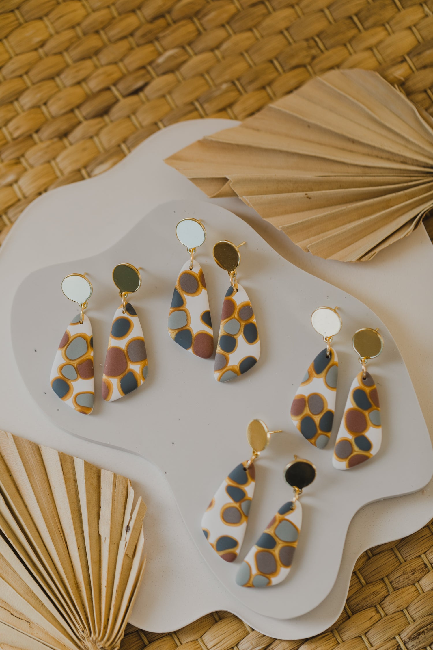 golden earrings with acrylic in white, petrol and brown
