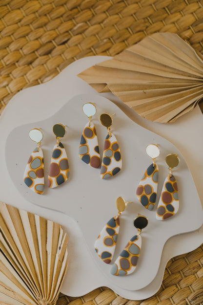 golden earrings with acrylic in white, petrol and brown