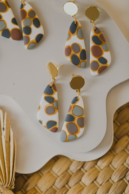 golden earrings with acrylic in white, petrol and brown