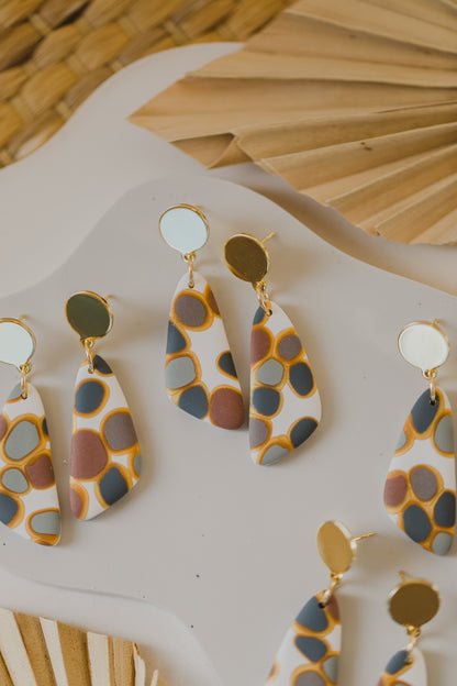 golden earrings with acrylic in white, petrol and brown