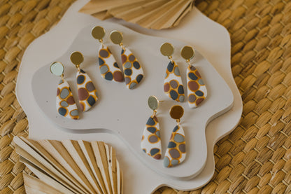 golden earrings with acrylic in white, petrol and brown