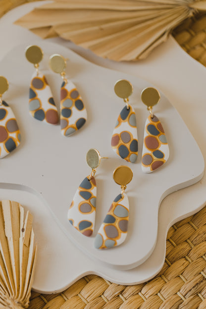 golden earrings with acrylic in white, petrol and brown