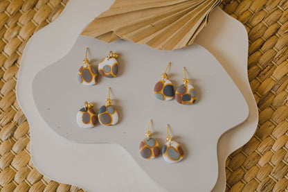 golden earrings with acrylic in white, petrol and brown