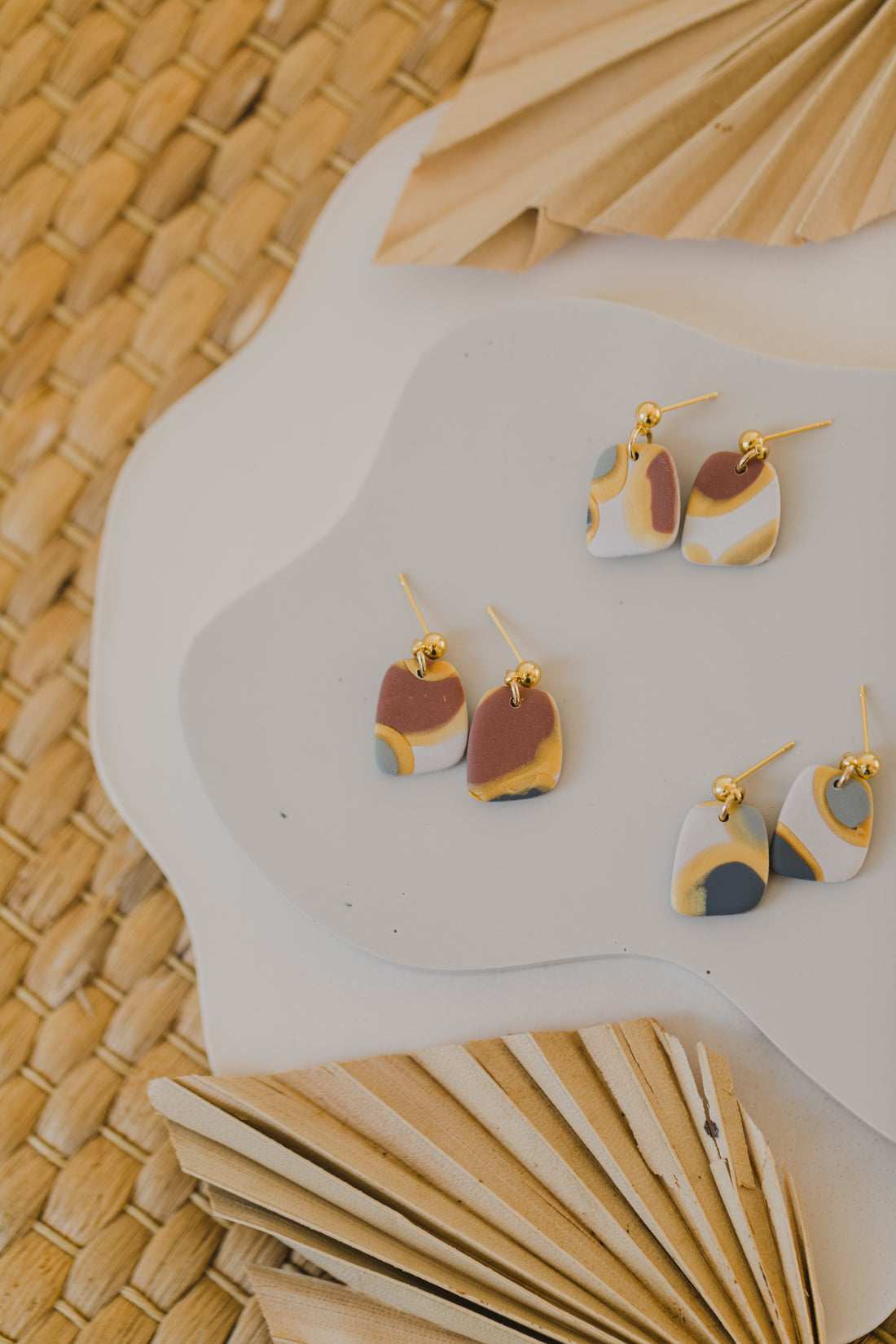 golden earrings with acrylic in white, petrol and brown