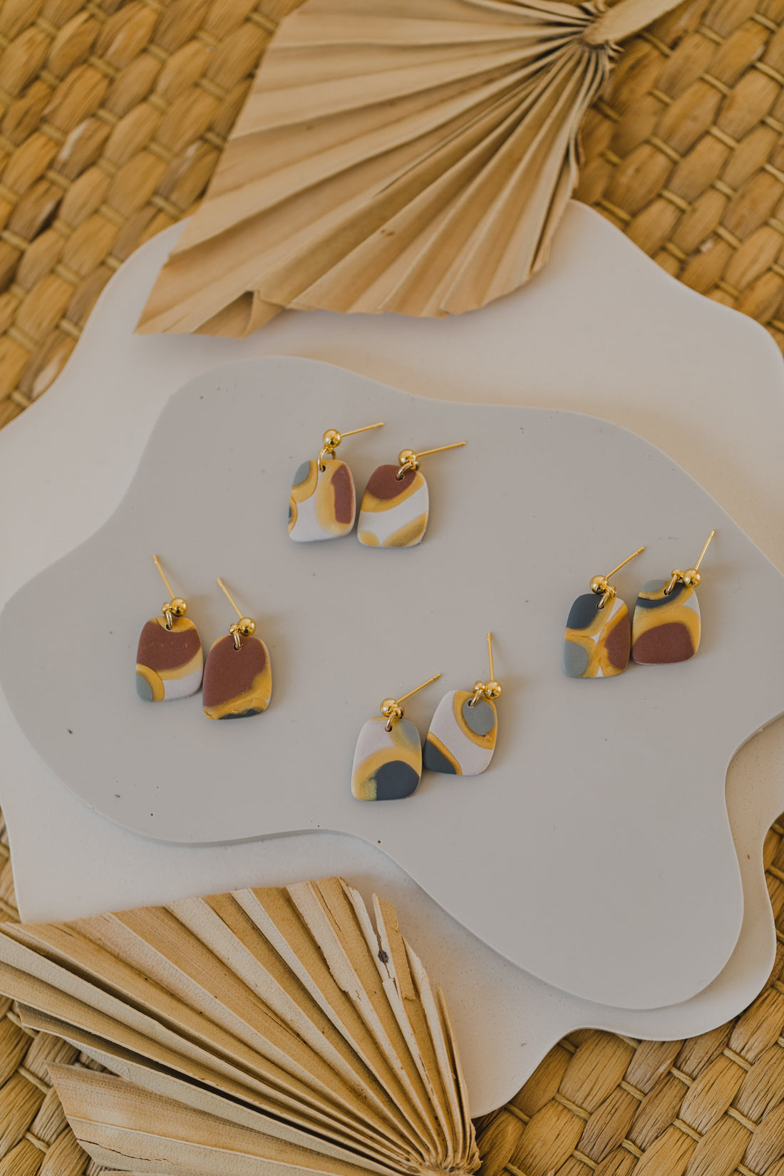 golden earrings with acrylic in white, petrol and brown