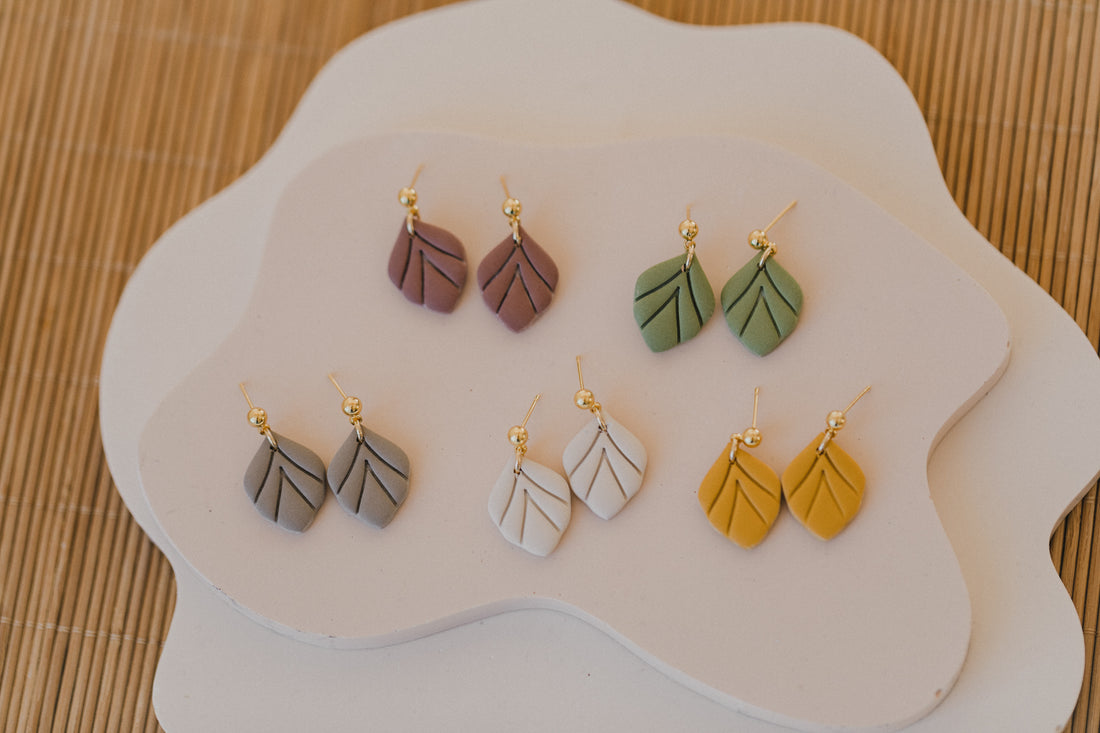 golden earrings with acrylic in white, petrol and brown