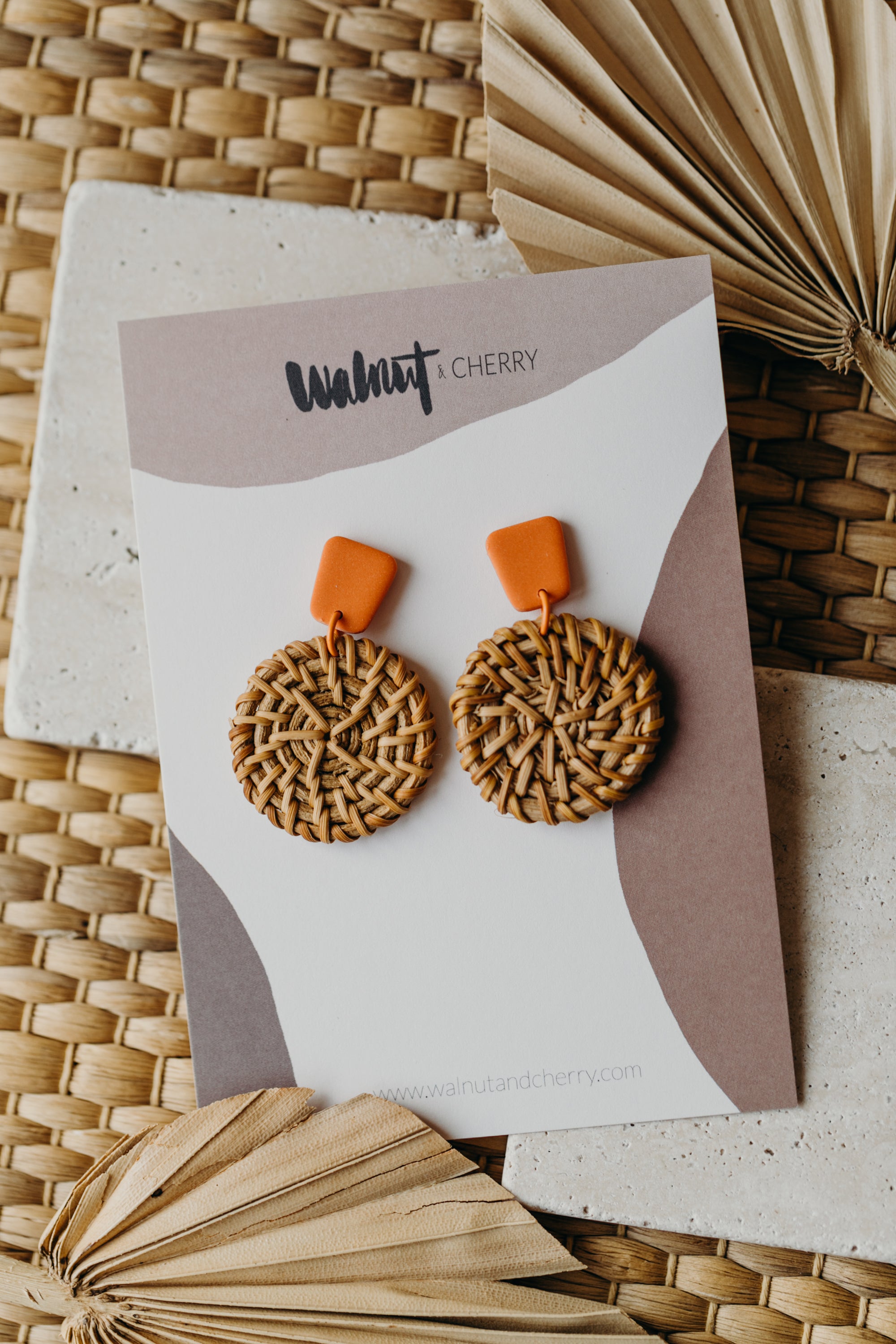 square polymer clay earrings in orange with round rattan pendant