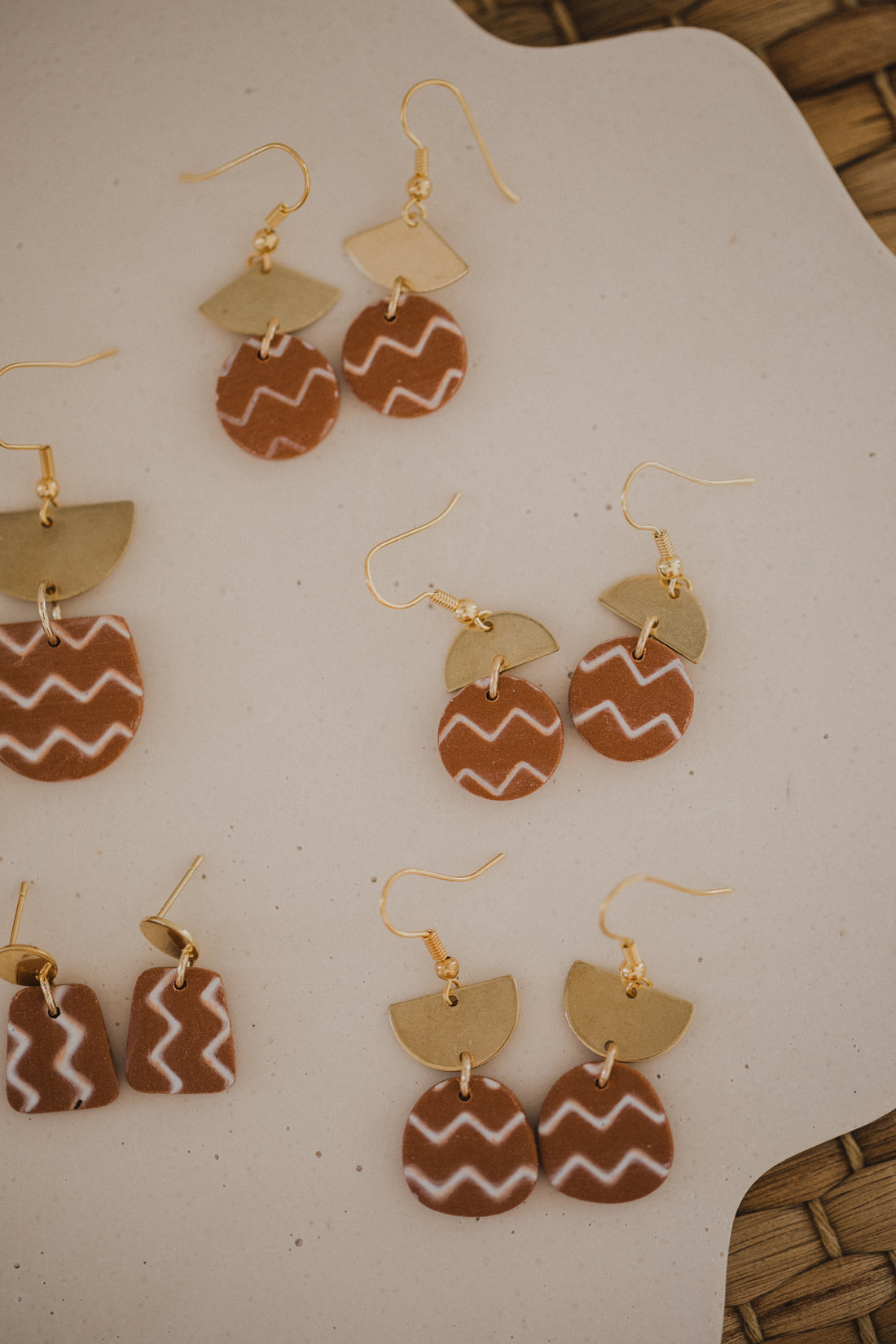 golden earrings with acrylic in white, petrol and brown