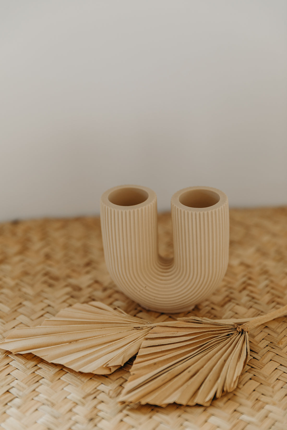 small beige U-shaped vase