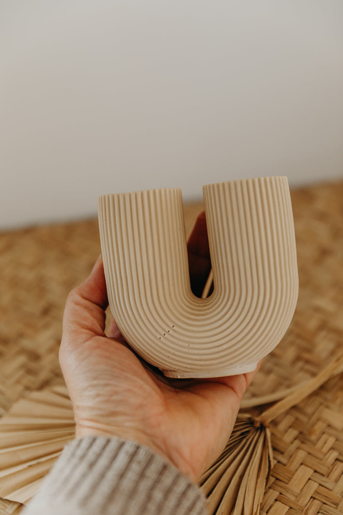 small beige U-shaped vase