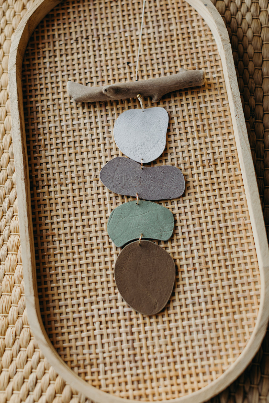 multicolored wall mobile made of polymer clay and driftwood