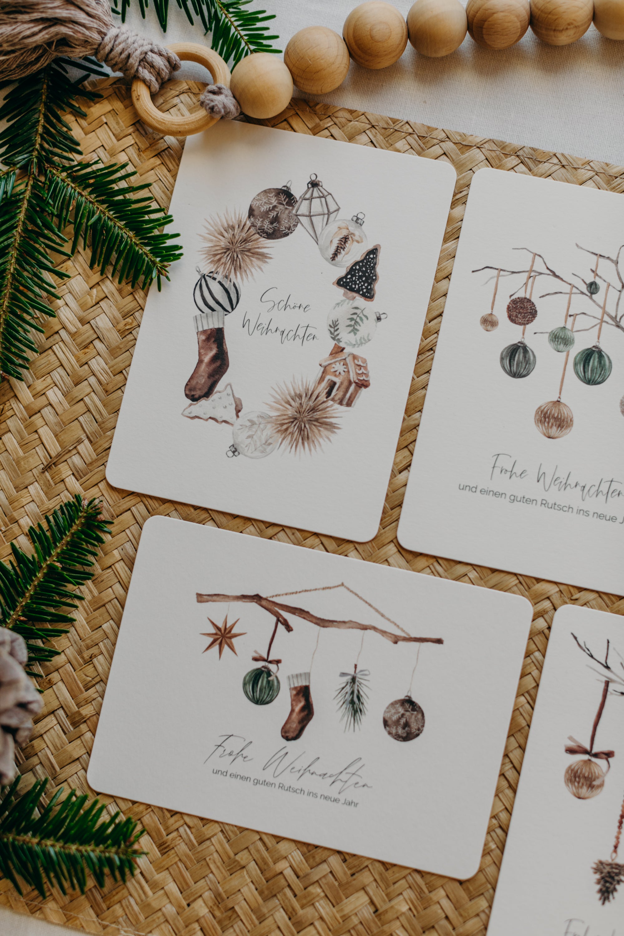 Christmas postcard branch with brown socks, star and Christmas tree balls