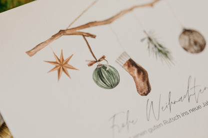 Christmas postcard branch with brown socks, star and Christmas tree balls