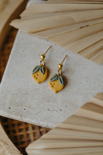 Hoop earrings with round polymer clay pendant and leaf