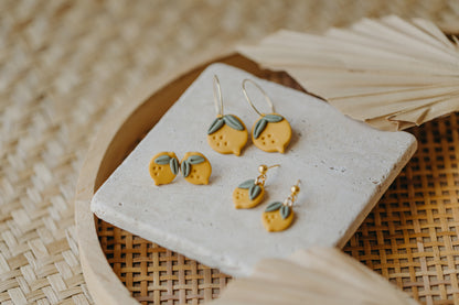 Hoop earrings with round polymer clay pendant and leaf