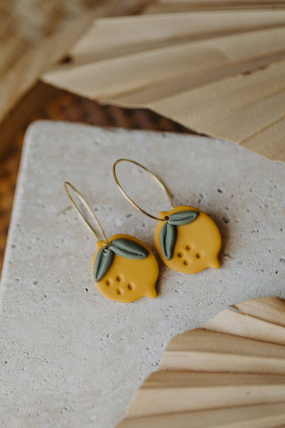 Hoop earrings with round polymer clay pendant and leaf